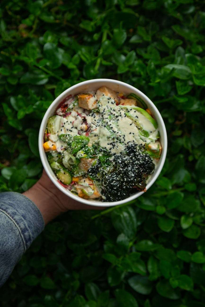 delicious healthy salad bowl on green background