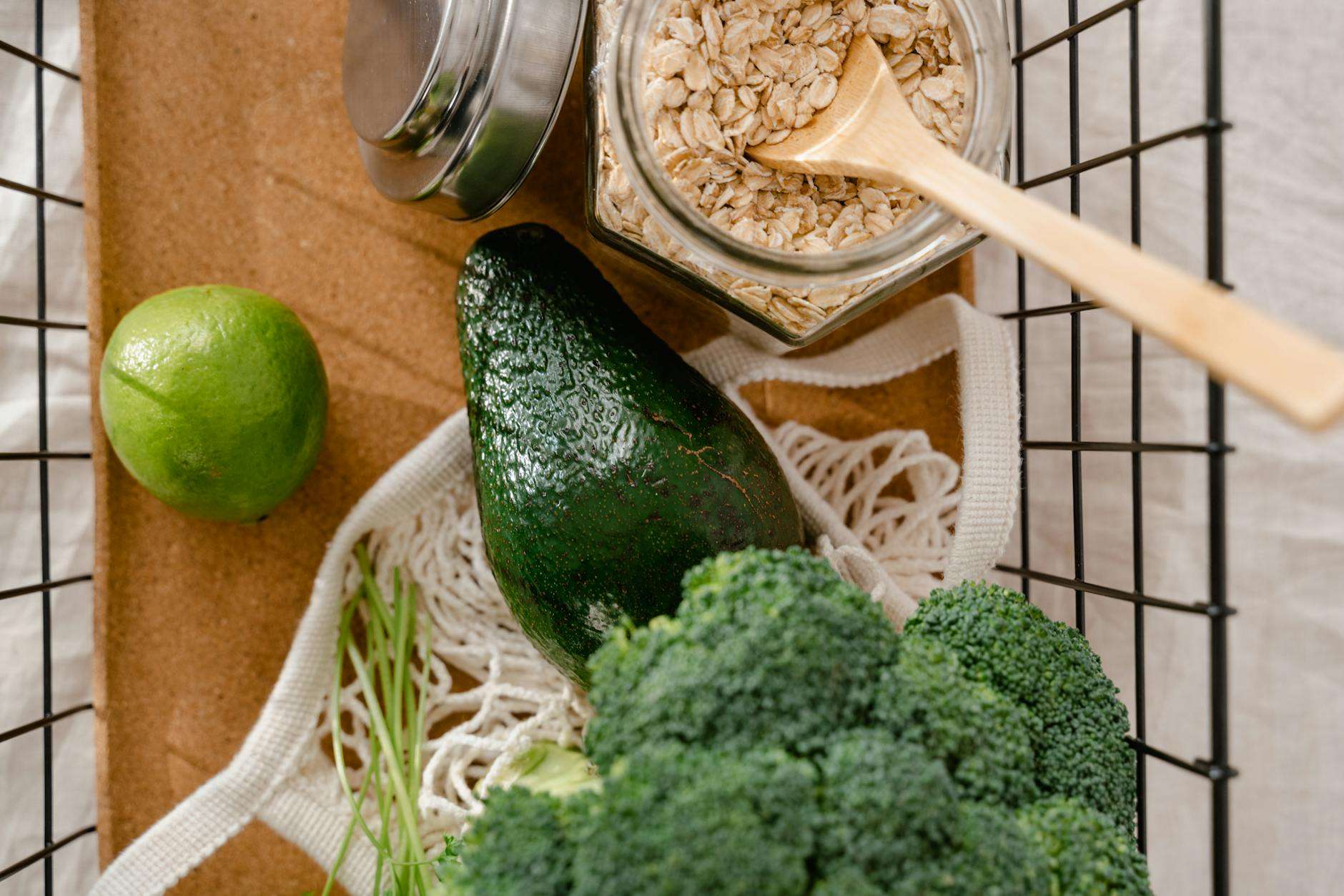 fruits and vegetable in a steel basket with a jar of oats