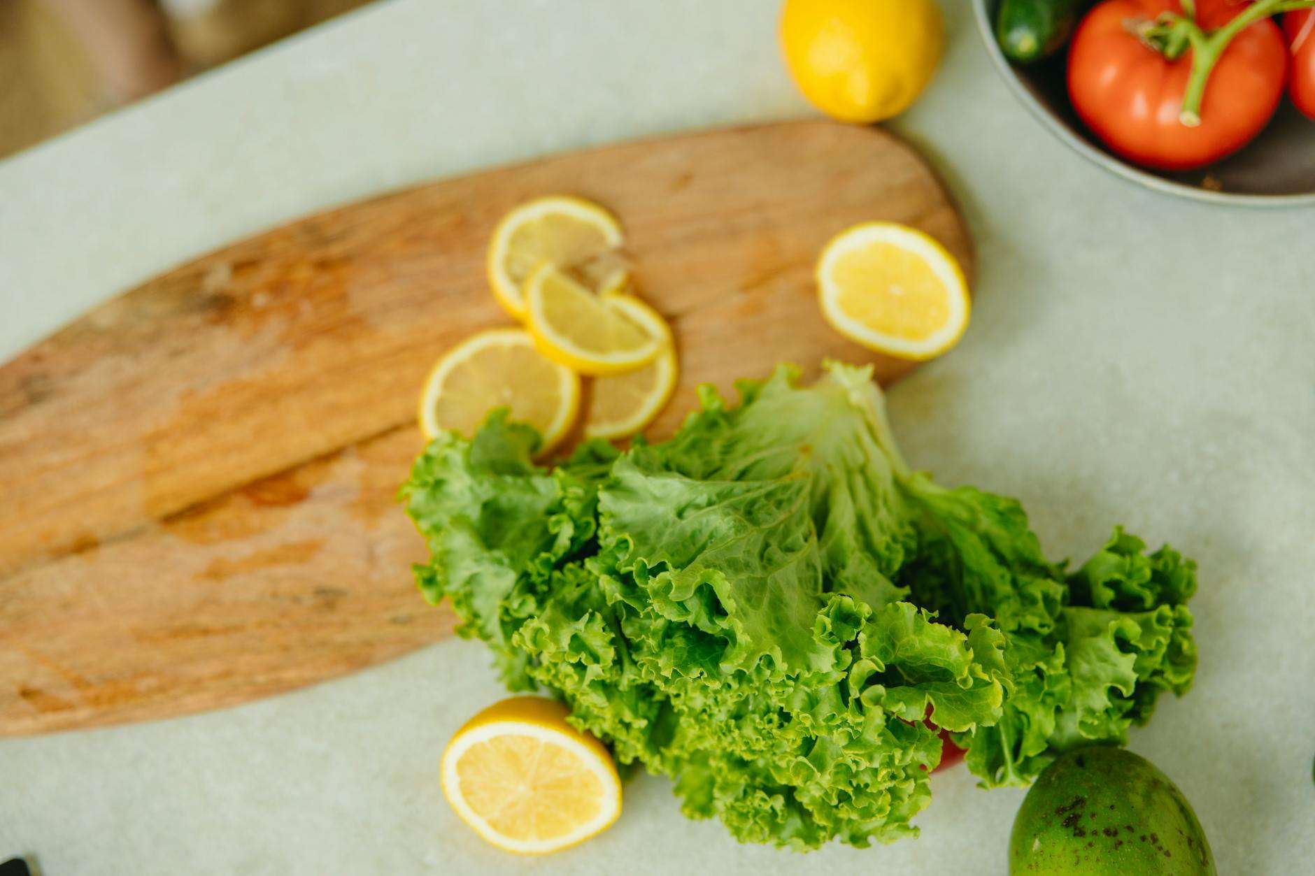 close up shot of lettuce and lemons on the table